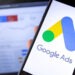 smartphone with Google Ads on the screen and display notebook background. Ads is a service of contextual, basically, search advertising from Google. Moscow, Russia - August 25, 2019